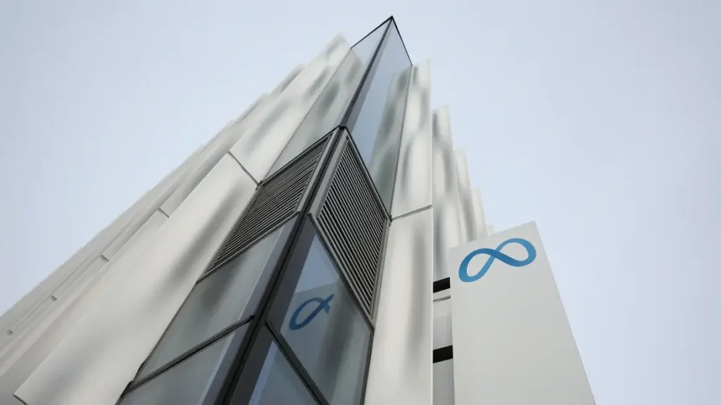 A tall building featuring the prominent Meta blue sign, symbolizing a corporate presence in an urban environment.