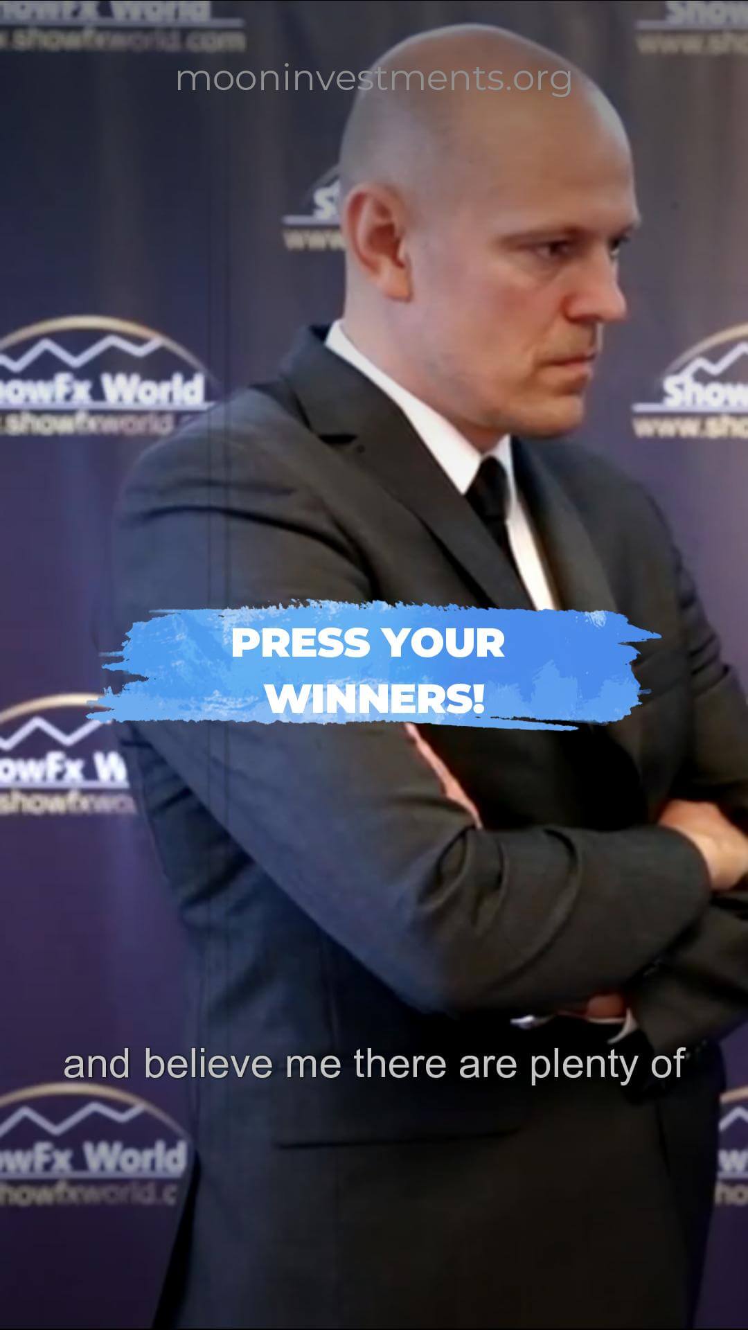 Bald man in a suit, arms crossed, with text overlay reading "PRESS YOUR WINNERS!".